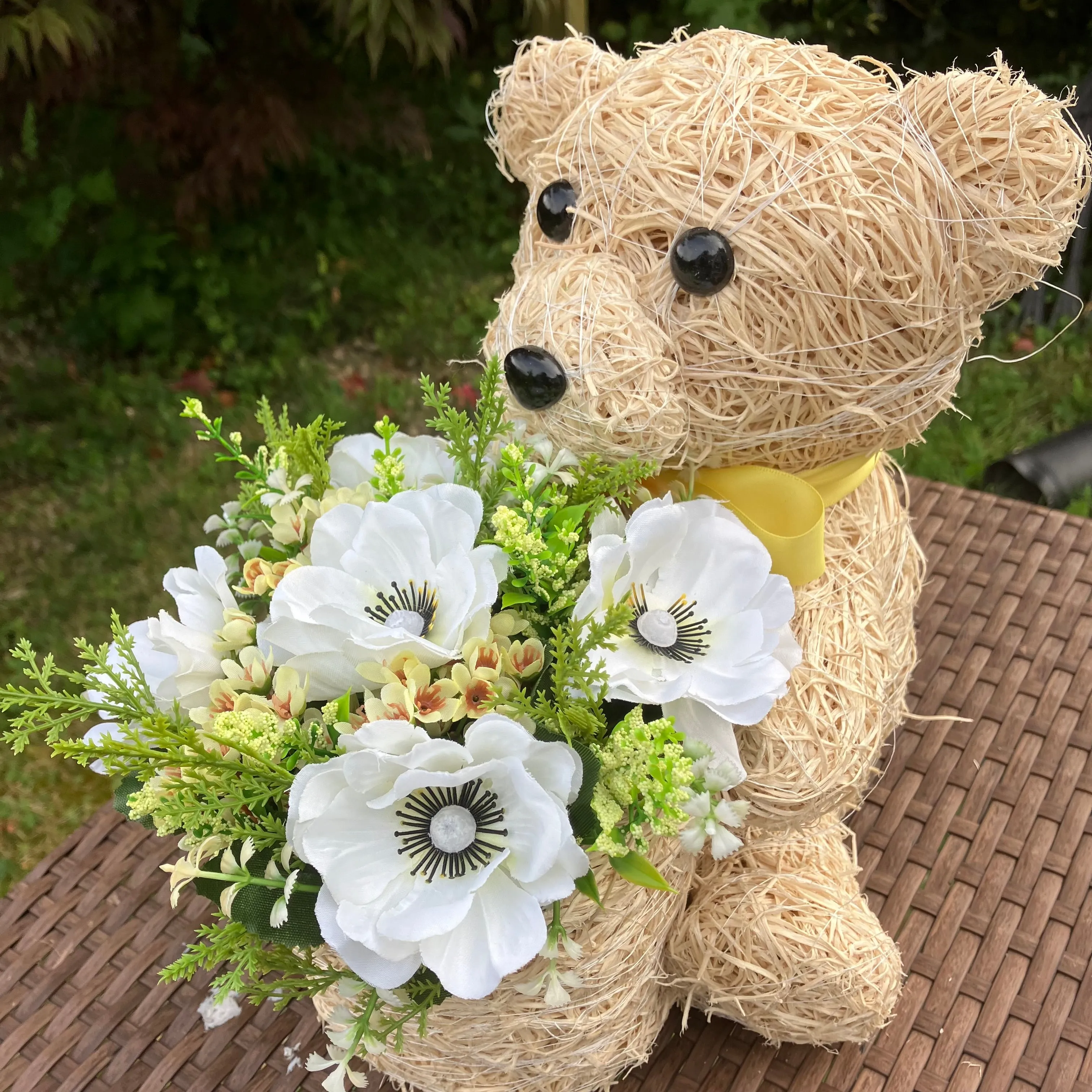Child’s memorial teddy planter with yellow and cream artificial flowers