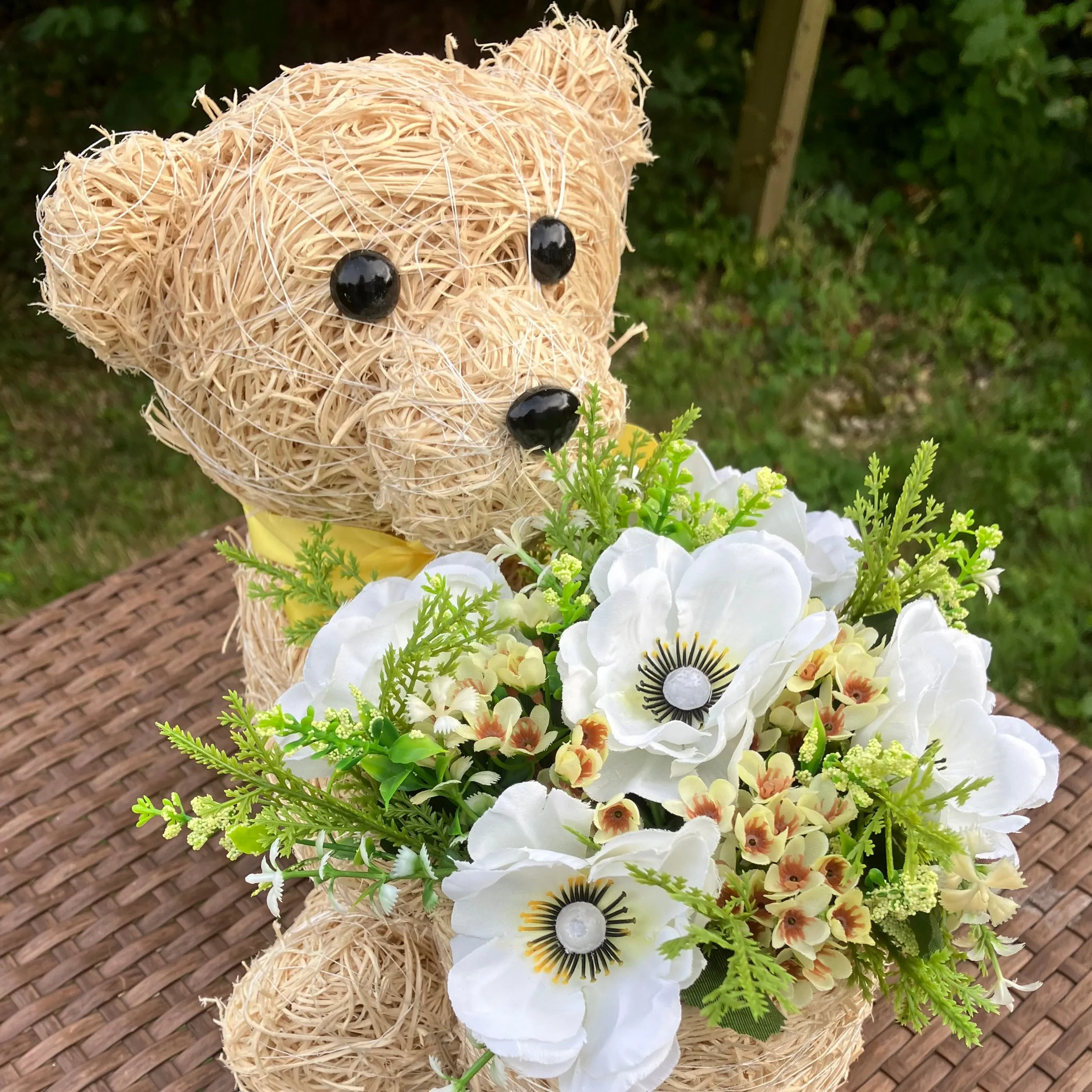 Child’s memorial teddy planter with yellow and cream artificial flowers